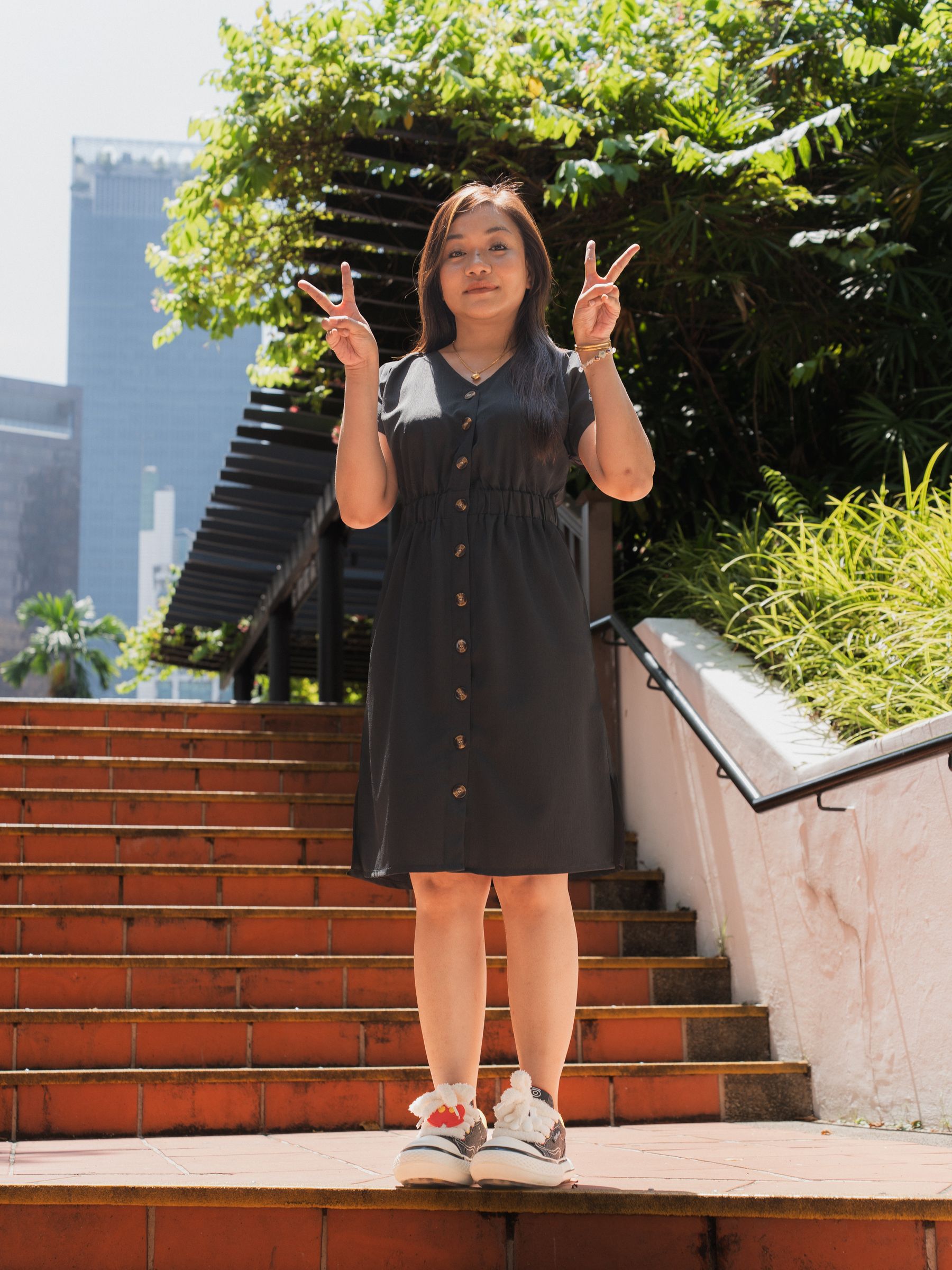 Playful solo portrait with a peace sign