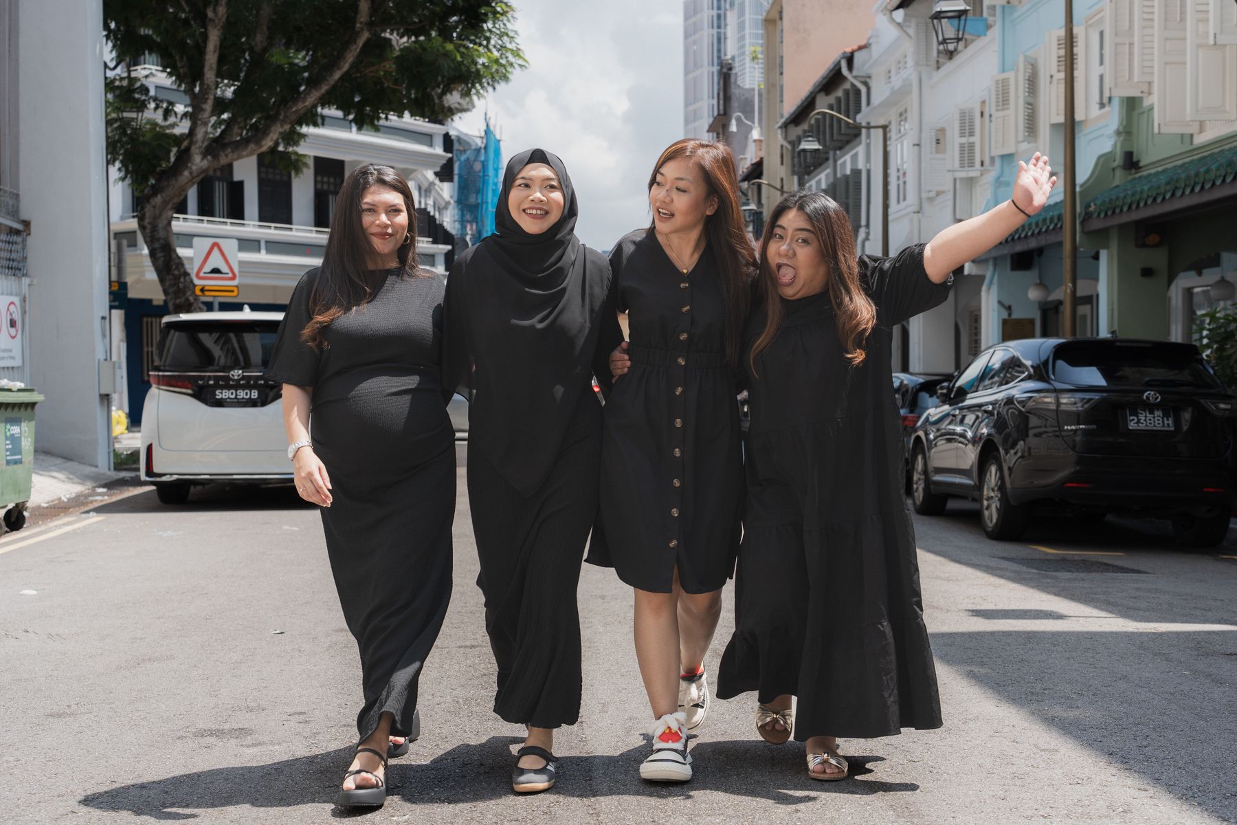 Walking arm in arm down the street, laughing
