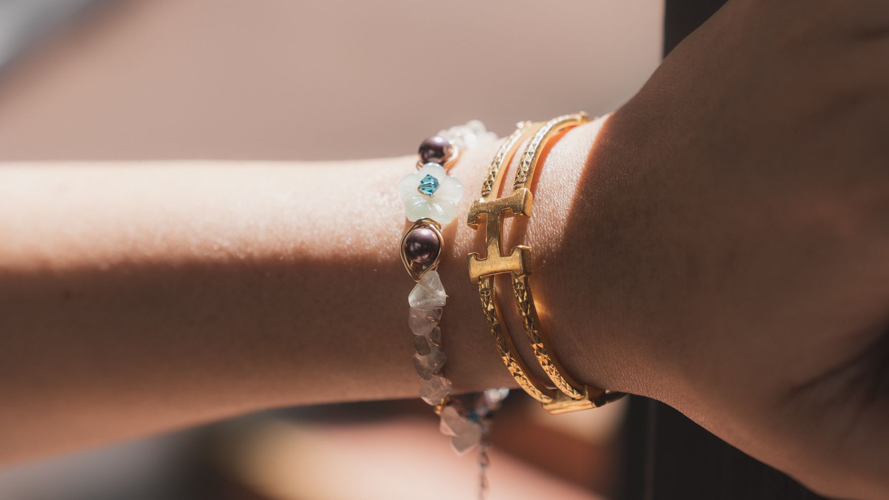Detail of stacked bracelets in afternoon light